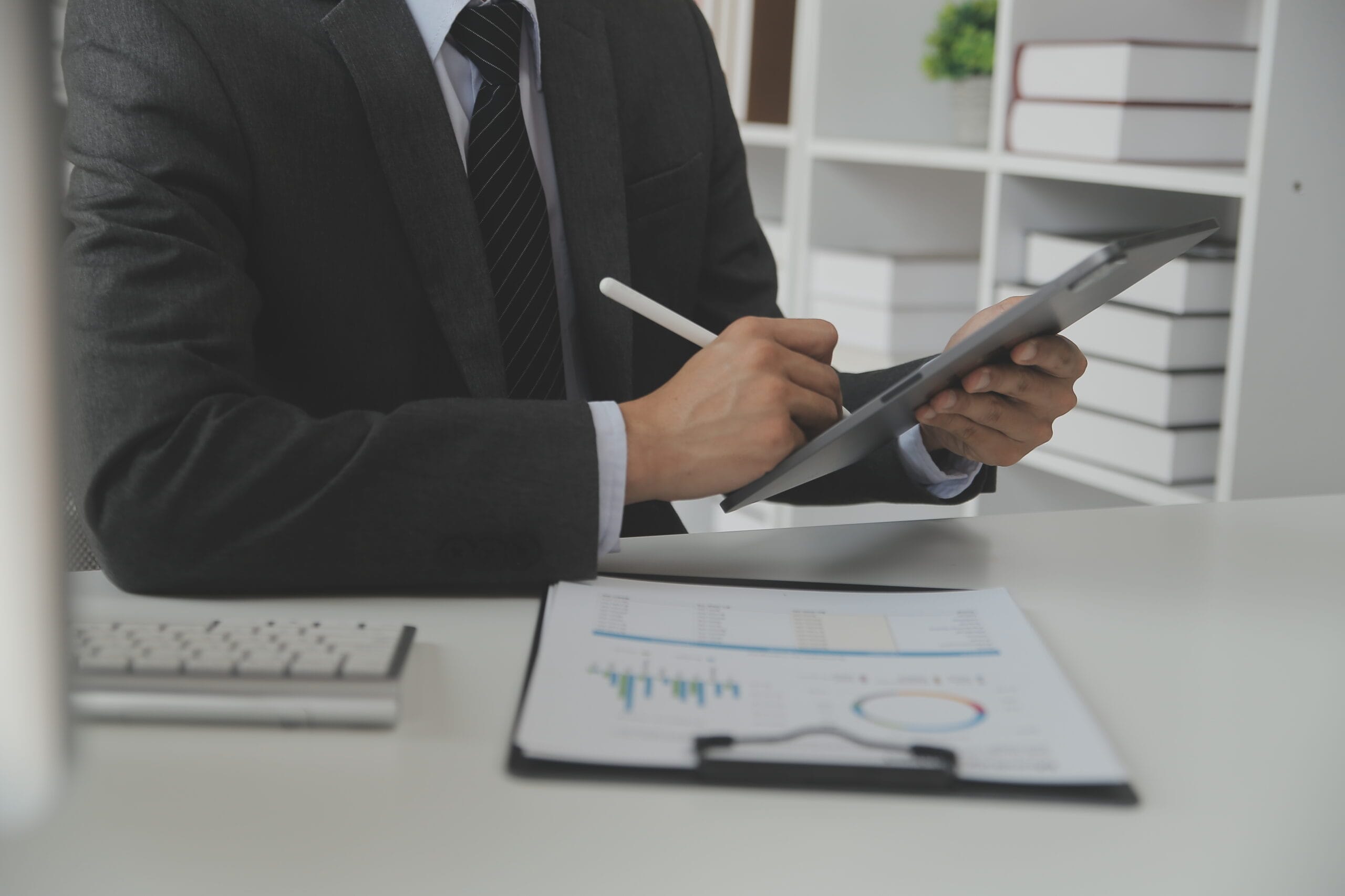 Group of confident business people point to graphs and charts to analyze market data, balance sheet, account, net profit to plan new sales strategies to increase production capacity.